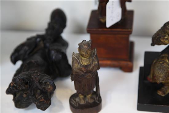 A Chinese gilt lacquered wood seated figure of Guandi, 18th / 19th century, and three other Chinese figures, all with some faults